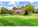 Beautiful brick home with manicured lawn and mature trees at 3706 Song Sparrow Dr, Matthews, NC 28104