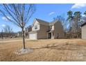 Side view of a well-maintained two-story home showcasing its architectural design and landscaping at 3735 Ernie Dr, Charlotte, NC 28269