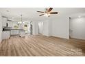 Bright open floor plan with hardwood floors and white walls leading to the kitchen and stairs at 443 Faith Sw Dr, Concord, NC 28027