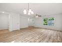 Open-concept living room, hardwood floors, and ample natural light at 445 Faith Sw Dr, Concord, NC 28027