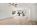 Bright, open-concept living room with hardwood floors, ceiling fan, and ample natural light at 445 Faith Sw Dr, Concord, NC 28027