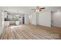 Open-concept living room boasts hardwood floors, and access to kitchen and staircase at 445 Faith Sw Dr, Concord, NC 28027