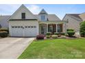 Inviting home boasts a two-car garage, manicured lawn, and a welcoming front porch at 5238 Prosperity View Dr, Charlotte, NC 28269