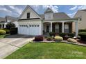 Well-maintained house with a two-car garage, a manicured lawn, and tasteful landscaping at 5238 Prosperity View Dr, Charlotte, NC 28269