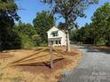 Charming two-story home with gravel driveway and a partially framed wooden fence on a sunny, landscaped lot at 5306 Lee Massey Rd, Waxhaw, NC 28173