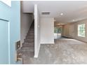 Inviting living area with plush carpeting, neutral walls, and staircase, leading to a bright and spacious living space at 5306 Lee Massey Rd, Waxhaw, NC 28173