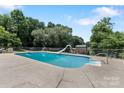 Large, in-ground residential swimming pool with surrounding trees at 5563 Grace Chapel Rd, Hickory, NC 28601