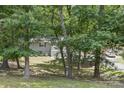 Exterior of home surrounded by lush green trees at 613 Davis St, Lancaster, SC 29720