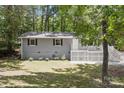 View of the home's exterior, showcasing the charming front yard and lush surroundings at 613 Davis St, Lancaster, SC 29720