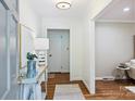 Bright entryway showcasing hardwood floors, stylish console table, and neutral decor at 6150 Rocky Falls Rd, Charlotte, NC 28211