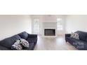 Bright living room featuring a fireplace, neutral walls, and modern flooring at 6825 Woodleaf Rd, Woodleaf, NC 27054