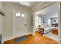 Welcoming foyer with hardwood floors that lead into a bright living space with a comfortable sofa at 7026 Tabor Ln, Charlotte, NC 28211
