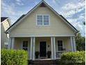 Inviting home featuring a classic design, large windows, and a well-maintained front garden at 7344 Gilead Rd, Huntersville, NC 28078