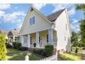 Side view of a home with a welcoming front porch, white columns, and lush green lawn at 7344 Gilead Rd, Huntersville, NC 28078