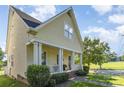 Charming home with a welcoming front porch, showcasing classic architectural details and landscaping at 7344 Gilead Rd, Huntersville, NC 28078