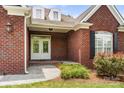 Inviting brick home entrance with double doors, manicured landscaping, and charming architectural details at 765 Cherry Hills Pl, Rock Hill, SC 29730