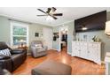 Cozy living room with hardwood floors and a ceiling fan, ideal for relaxation at 805 Caldwell St, Belmont, NC 28012