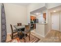 A dining area located adjacent to the kitchen, featuring a table and four chairs at 8119 Tremaine Ct # E, Charlotte, NC 28227