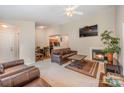 Spacious living room with a fireplace, TV, and a view into the dining area and kitchen at 8119 Tremaine Ct # E, Charlotte, NC 28227