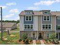 Charming townhome exterior with a well-maintained lawn, beautiful landscaping, and inviting entrance at 8332 Waxhaw Hwy, Waxhaw, NC 28173