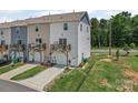 Townhome featuring exterior garages, decks, and a well-maintained lawn at 8332 Waxhaw Hwy, Waxhaw, NC 28173