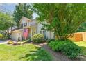 Beautifully landscaped front yard with mature trees and a well-maintained lawn at 8701 Appaloosa Way Ln, Charlotte, NC 28216