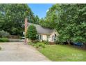 Charming one-story home with mature trees, manicured lawn and blue accents creating curb appeal at 111 Beacon Hills Dr, Gastonia, NC 28056
