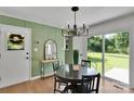 Dining room features a sleek table and chairs, a modern chandelier, and sliding glass doors at 113 Lou Dr, Gastonia, NC 28052