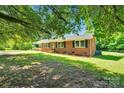 Charming brick home featuring manicured lawn and classic black shutters at 113 Lou Dr, Gastonia, NC 28052