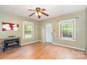 Spacious living room featuring hardwood floors, fireplace, and a front door at 1145 Earl Rd, Shelby, NC 28152