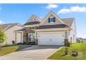 Beautiful home with a large driveway, two-car garage, neutral siding, brick accents, and a well-maintained lawn at 125 White Apple Way, Statesville, NC 28625