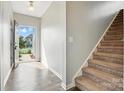 Bright entryway featuring hardwood floors, a staircase, and an open view to the outdoors at 12522 Palomino Dr, Midland, NC 28107