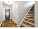 Inviting entryway with hardwood floors, staircase, and a modern black front door at 12522 Palomino Dr, Midland, NC 28107
