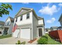 Charming two-story home with a two-car garage and an American flag waving in front at 12522 Palomino Dr, Midland, NC 28107