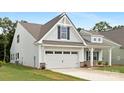 Side view of a lovely home with a two-car garage and manicured lawn at 170 Aspire Cir # 31, Wingate, NC 28174