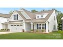 Charming home featuring a two-car garage and a cozy front porch at 170 Aspire Cir # 31, Wingate, NC 28174