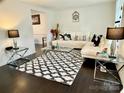 Bright living room features a stylish black and white rug, with upscale lamps, and modern furniture at 2008 Bantry Ln, Charlotte, NC 28262