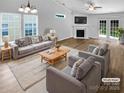 Bright living room with vaulted ceilings, a fireplace, and new hardwood flooring at 2010 Kansas City Dr, Monroe, NC 28110