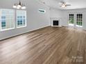 Bright living room with vaulted ceilings, a fireplace, and new hardwood flooring at 2010 Kansas City Dr, Monroe, NC 28110