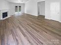 Spacious open floor plan featuring new hardwood flooring, fireplace, and access to backyard at 2010 Kansas City Dr, Monroe, NC 28110