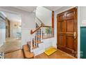 Foyer features a staircase with patterned tiles and an original hardwood door at 2034 Lanier Ave, Charlotte, NC 28205