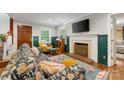 Cozy living room featuring a fireplace, hardwood floors, and lots of natural light at 2034 Lanier Ave, Charlotte, NC 28205