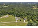 Expansive aerial view of a home with a pool, surrounded by lush greenery and ample land at 247 Helton Rd, Cherryville, NC 28021