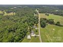 Serene aerial view of a property with a house, pool, and surrounding landscape at 247 Helton Rd, Cherryville, NC 28021