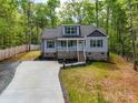 Beautiful gray home featuring a covered front porch with a well-maintained lawn and driveway at 292 Manchester Rd, Mount Gilead, NC 27306