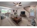 Open-concept living room featuring modern furniture, a ceiling fan, and connections to kitchen and dining at 292 Manchester Rd, Mount Gilead, NC 27306