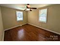 Bedroom with hardwood floors, neutral walls, ceiling fan and two windows at 309 Fannie Cir, Charlotte, NC 28205