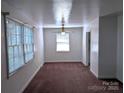 Bright living room with large windows, neutral paint, and a ceiling fan at 309 Fannie Cir, Charlotte, NC 28205