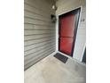 Exterior entrance with red door and modern light fixture at 3200 Heathstead Pl # E, Charlotte, NC 28210