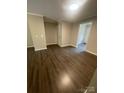 Spacious living room featuring hardwood floors and neutral paint at 3200 Heathstead Pl # E, Charlotte, NC 28210